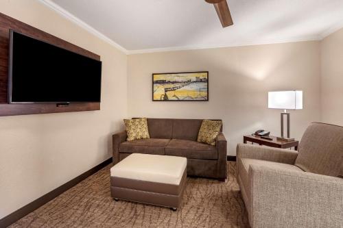 a living room with two couches and a flat screen tv at Best Western Premier Bridgewood Hotel Resort in Neenah