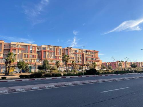 an empty road with buildings on the side of a street at Modern Apartment Airport in Marrakech
