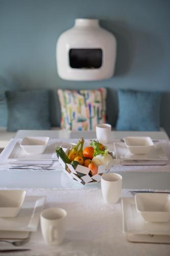 a table with a plate of food on it at Moscova Luxury B&B in Milan