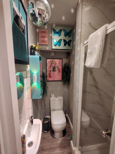 a small bathroom with a toilet and a sink at Studio 13 Brighton in Brighton & Hove