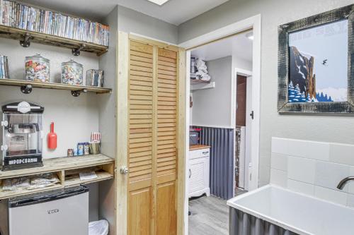a kitchen with a wooden door and a sink at 11 Mi to Bozeman Family Home with Movie Room! in Belgrade