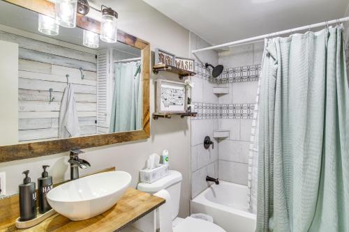 a bathroom with a sink and a tub and a toilet at 11 Mi to Bozeman Family Home with Movie Room! in Belgrade