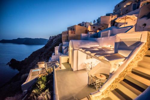 a view of the side of a building at night at Virginia's Cave Villas in Oia
