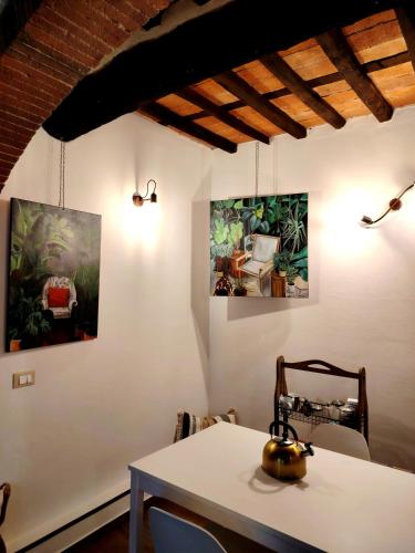 a room with three paintings on the wall at Claudia's Home La Suite in Pescia