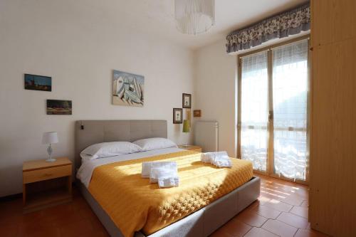 a bedroom with a bed and a large window at ModernShore - Garden Hideaway in Alba Adriatica