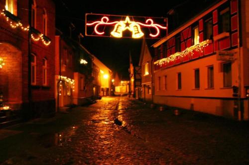 an empty street at night with christmas lights at Wohnung In Ilfeld Mit Grill Und Garten in Harztor