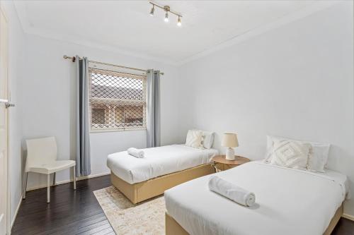 Ένα ή περισσότερα κρεβάτια σε δωμάτιο στο Peninsular Drive 1 bedroom