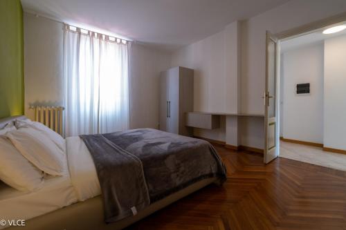 a bedroom with a bed and a large window at Residenza Cece' in Lecco