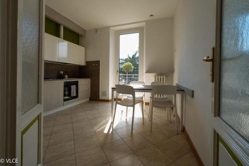 a kitchen with a table and chairs and a window at Residenza Cece' in Lecco