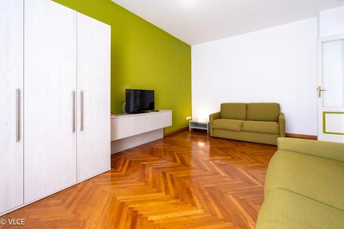 a living room with a couch and a tv at Residenza Cece' in Lecco