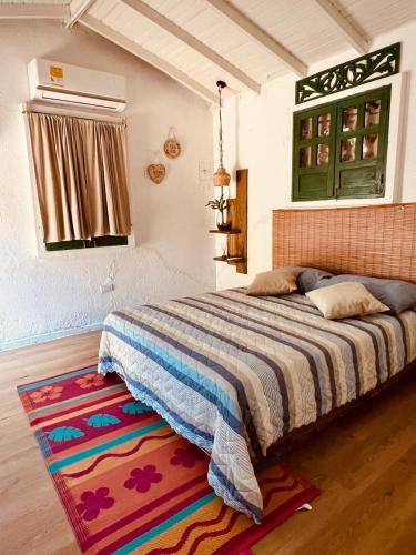 a bedroom with a bed with a colorful rug at Mohana in Puerto Colombia