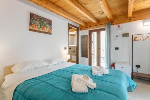 a bedroom with a large bed with towels on it at La carbonaia rooms in Agrigento in Agrigento