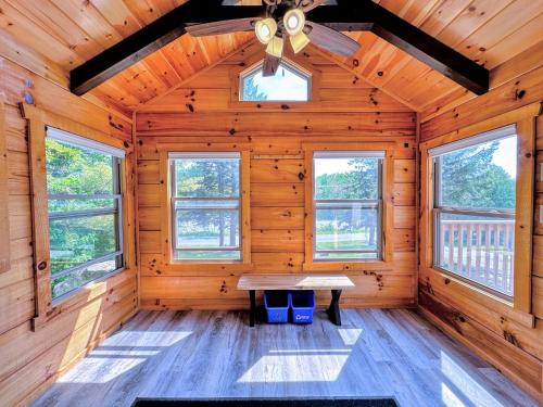 a wooden cabin with a table in the middle at BMV6 Tiny Home Topline in Carroll