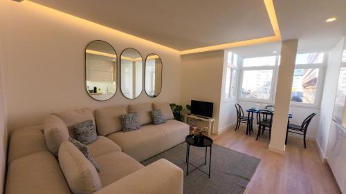 a living room with a couch and a table at Saldanha cozy apartament in Lisbon