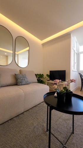 a living room with a couch and a table at Saldanha cozy apartament in Lisbon