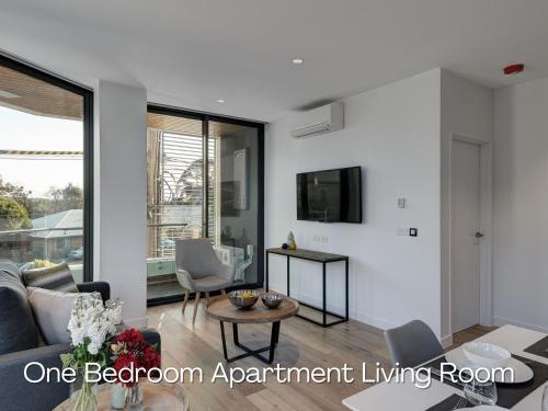 a living room with a couch and a table at Camberwell Serviced Apartments in Melbourne