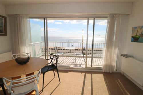 une pièce avec une table et une vue sur l'océan dans l'établissement La Croix du Sud By Tranquil at Home, à La Baule