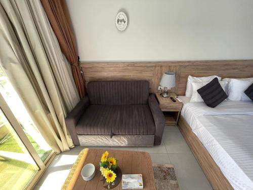 a room with a bed and a couch and a table at Scanddic Resort Hurghada in Hurghada