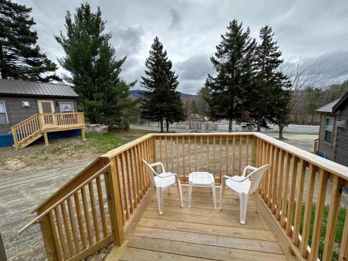 a deck with two chairs and a table on it at BMV7 Tiny Home Topline in Carroll