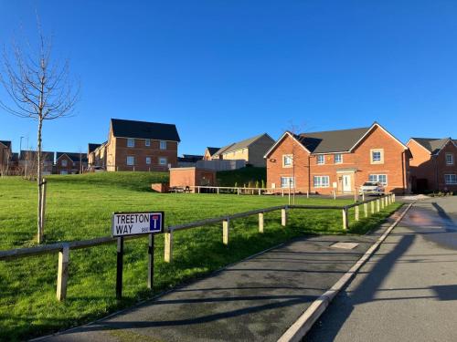 a street sign on a fence in a residential neighborhood at Sheffield 3-Bed Warm Comfy home in Orgreave