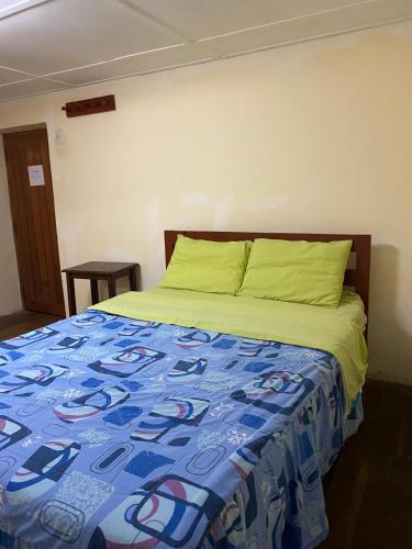 a bedroom with a bed with a blue comforter at Aventura Chachapoyas Backpackers in Chachapoyas