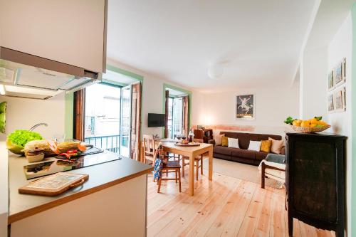 a kitchen and a living room with a table at Apartments in Historical Lisbon in Lisbon