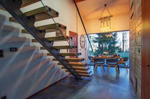a winding staircase in a dining room with a table at Bobrowa Ostoja in Łukta