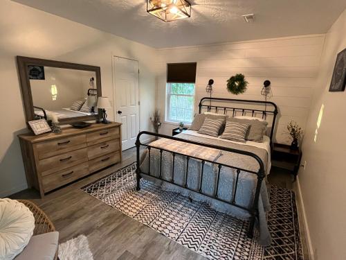 a bedroom with a bed and a large mirror at Country Hills Hideaway in Millersburg