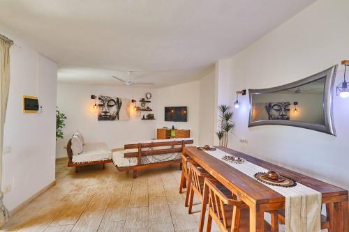 a living room with a table and a couch at Djadsal Moradias - by Bobbywashere in Santa Maria