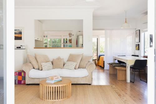 a living room with a couch and a table at Ro-ana for 8, Gerringong in Gerringong
