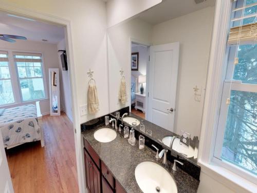 a bathroom with two sinks and a large mirror at Single Family Ship Bottom Wifi Beach Badges Decks Air Conditioning Granite Countertops Recently Renovate Single Family House In Ship Bottom in Ship Bottom