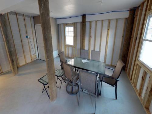a room with a table and chairs in a building at Single Family Ship Bottom Wifi Beach Badges Decks Air Conditioning Granite Countertops Recently Renovate Single Family House In Ship Bottom in Ship Bottom