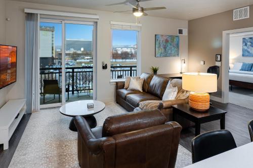 a living room with a couch and a table at Convention Ctr Bespoke Beauty - 2BD Pool,Gym,Hot tub,Pkg in Salt Lake City