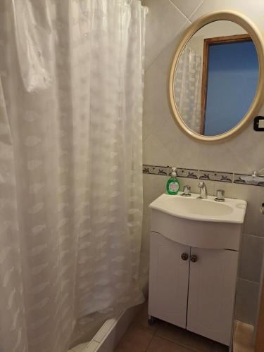 a bathroom with a sink and a mirror at Tranquilo duplex frente al mar in Monte Hermoso