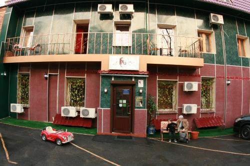 a red car parked in front of a building at YELLOW UNLIMITED HOTEL 4 in Kharkiv