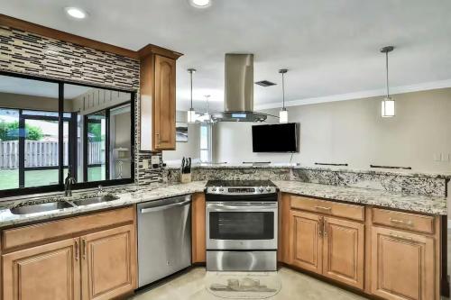 a kitchen with wooden cabinets and stainless steel appliances at Renovated 3BR Dog Friendly Pond View WD in Whitfield