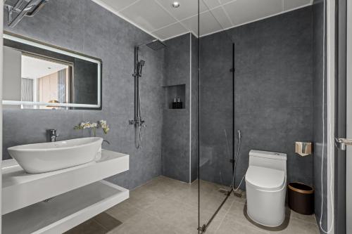 a bathroom with a sink and a toilet and a shower at Lavender Hotel Vân Đồn in Tài Xá