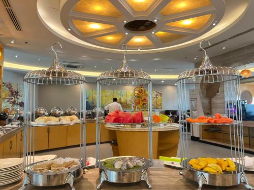 a buffet with many different types of food in cages at Dara Airport Hotel in Phnom Penh
