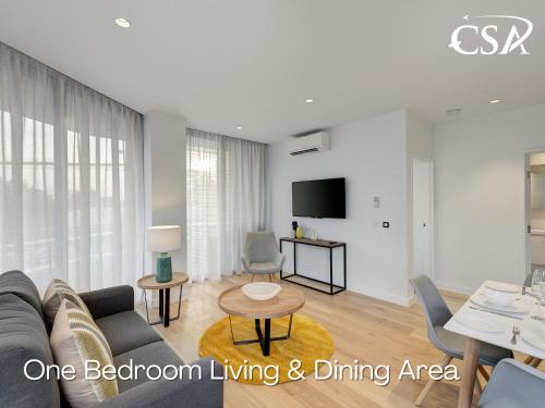 a living room with a couch and a table at Camberwell Serviced Apartments in Melbourne