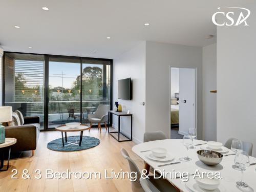 a living room with a table and a dining area at Camberwell Serviced Apartments in Melbourne