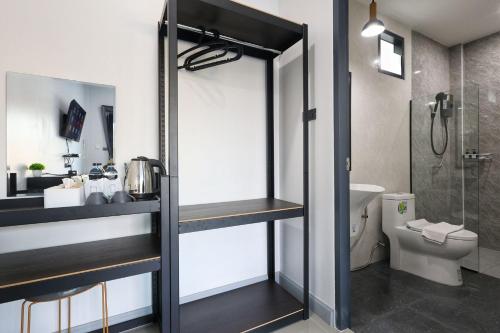 a bathroom with a shower and a toilet and a sink at Hillside Premium Hotel in Ban Huai Chiat