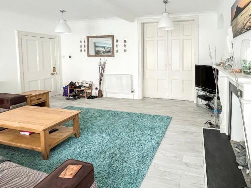a living room with a couch and a table at Seaglass in Marazion