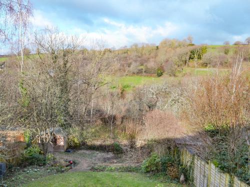 a view of a field with trees and a fence at Middle Wicket in Trusham