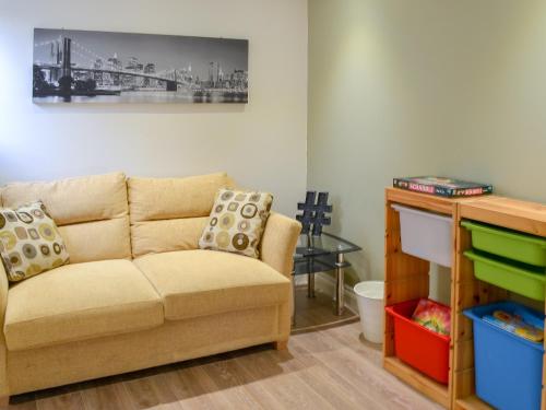 a living room with a couch and a table at Middle Wicket in Trusham