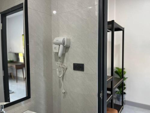 a hairdryer on a wall in a bathroom at Hillside Premium Hotel in Ban Huai Chiat