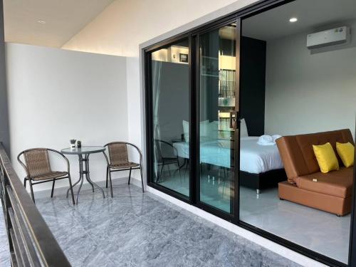 a room with a table and a couch and a bed at Hillside Premium Hotel in Ban Huai Chiat
