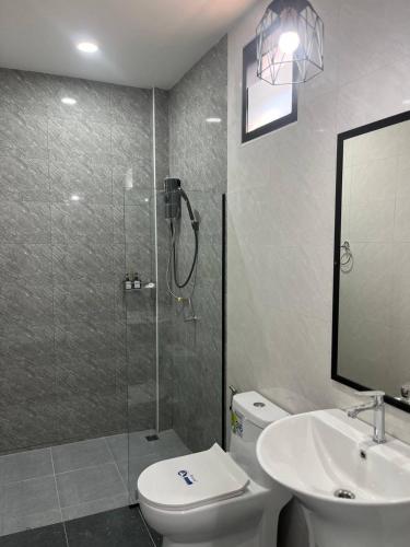 a bathroom with a shower and a toilet and a sink at Hillside Premium Hotel in Ban Huai Chiat