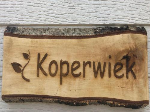 a sign on a wall with the word koperzik at Chalet near Antwerp with Nature Trails in Beulk