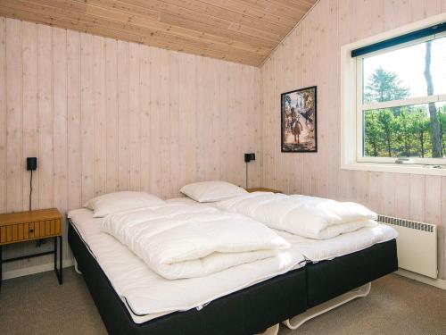 a large bed in a room with a window at 6 person holiday home in Ansager in Ansager