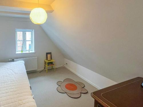 a bedroom with a bed with a flower rug on the floor at 6 person holiday home in Marstal in Marstal